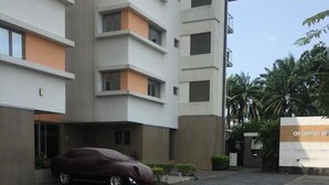 A multi-story building with a covered parking area. - Koza Town (Lagos)