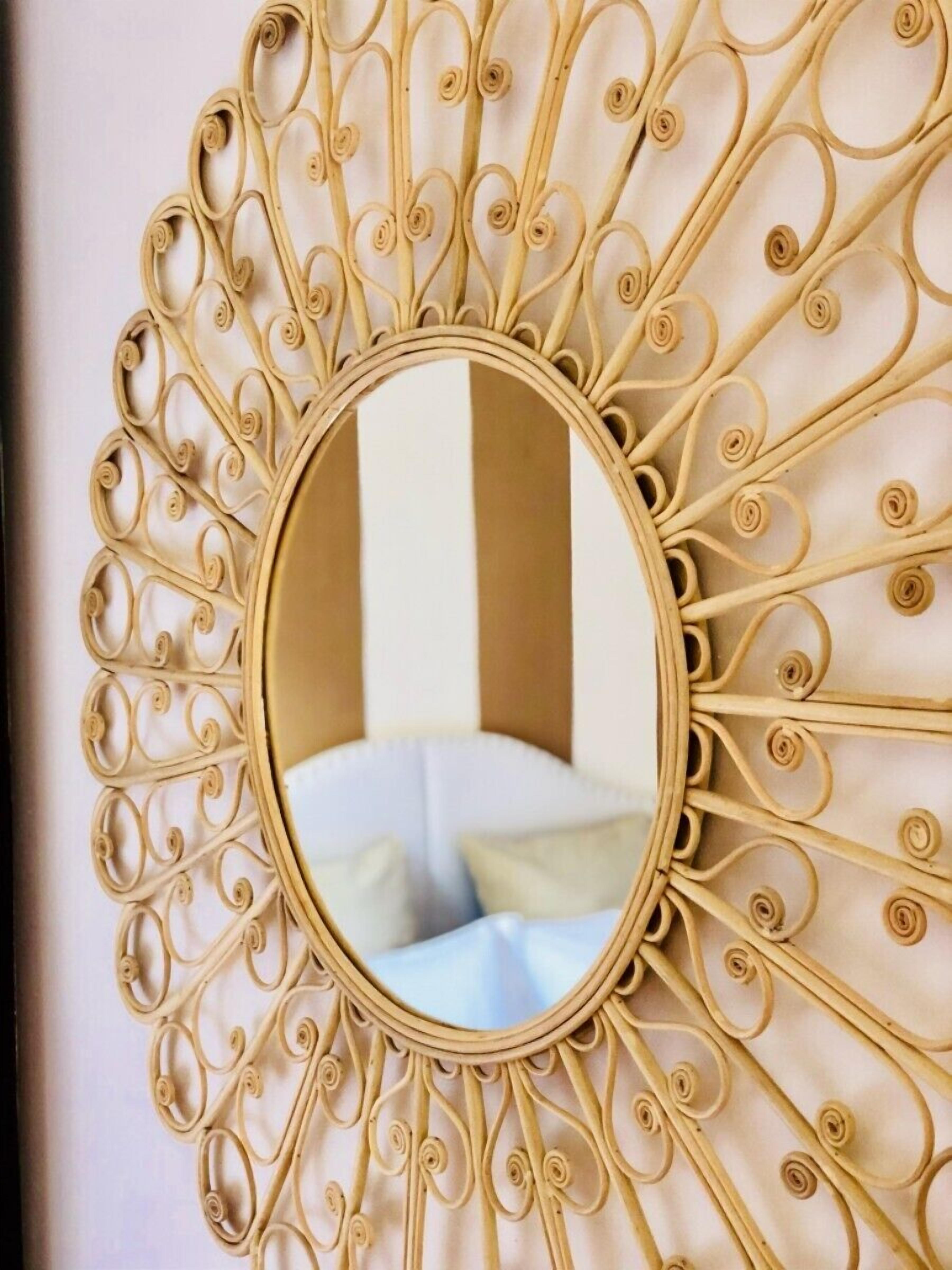 A wall-mounted mirror with a decorative, sunburst pattern.