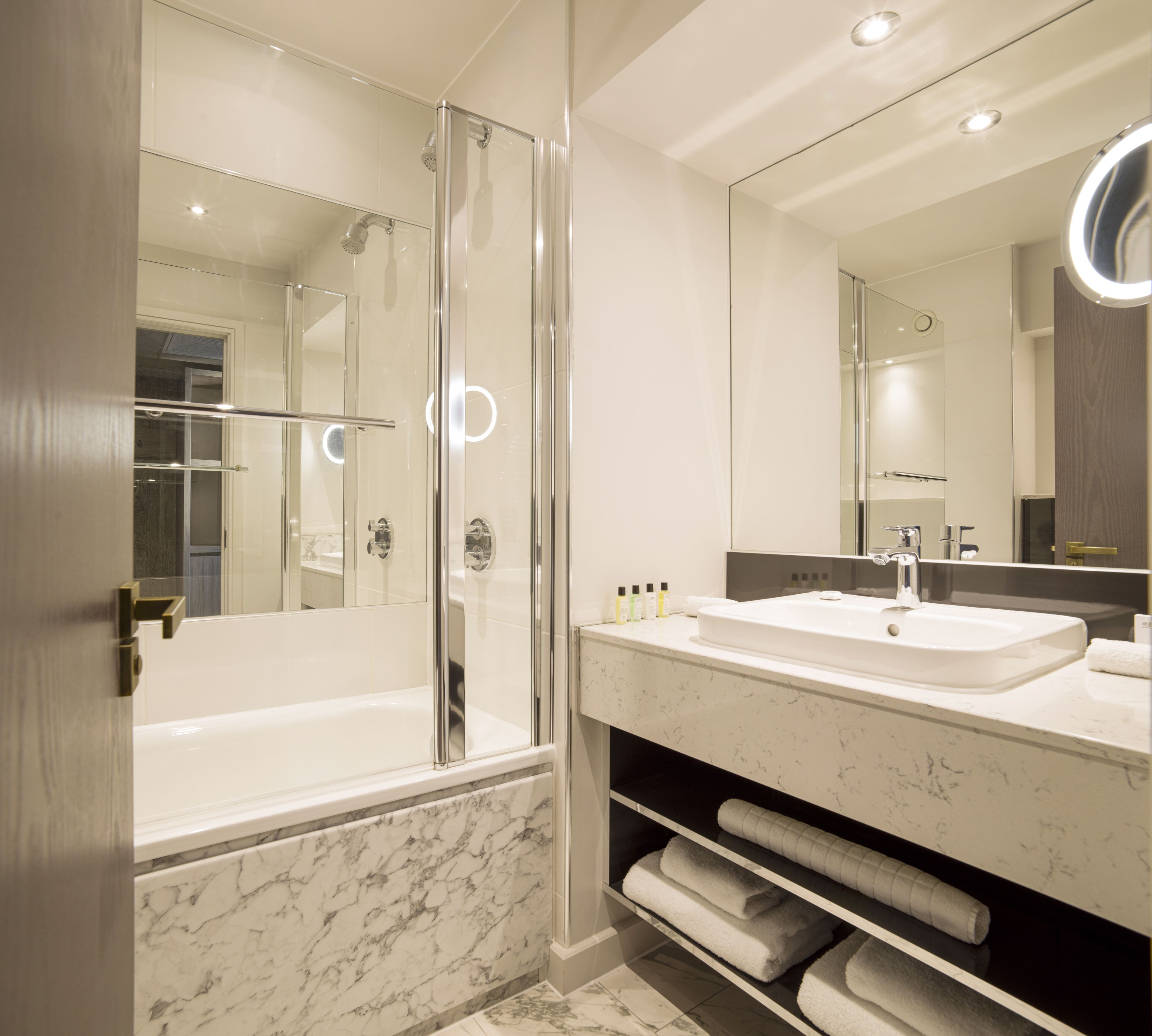 designer toiletries, hair dryer, towels, soap