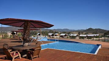 Seasonal outdoor pool, open 8:00 AM to 8:00 PM, pool umbrellas