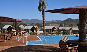 Seasonal outdoor pool, open 8:00 AM to 8:00 PM, pool umbrellas