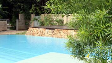 Outdoor pool, open 7 AM to 6 PM, pool loungers