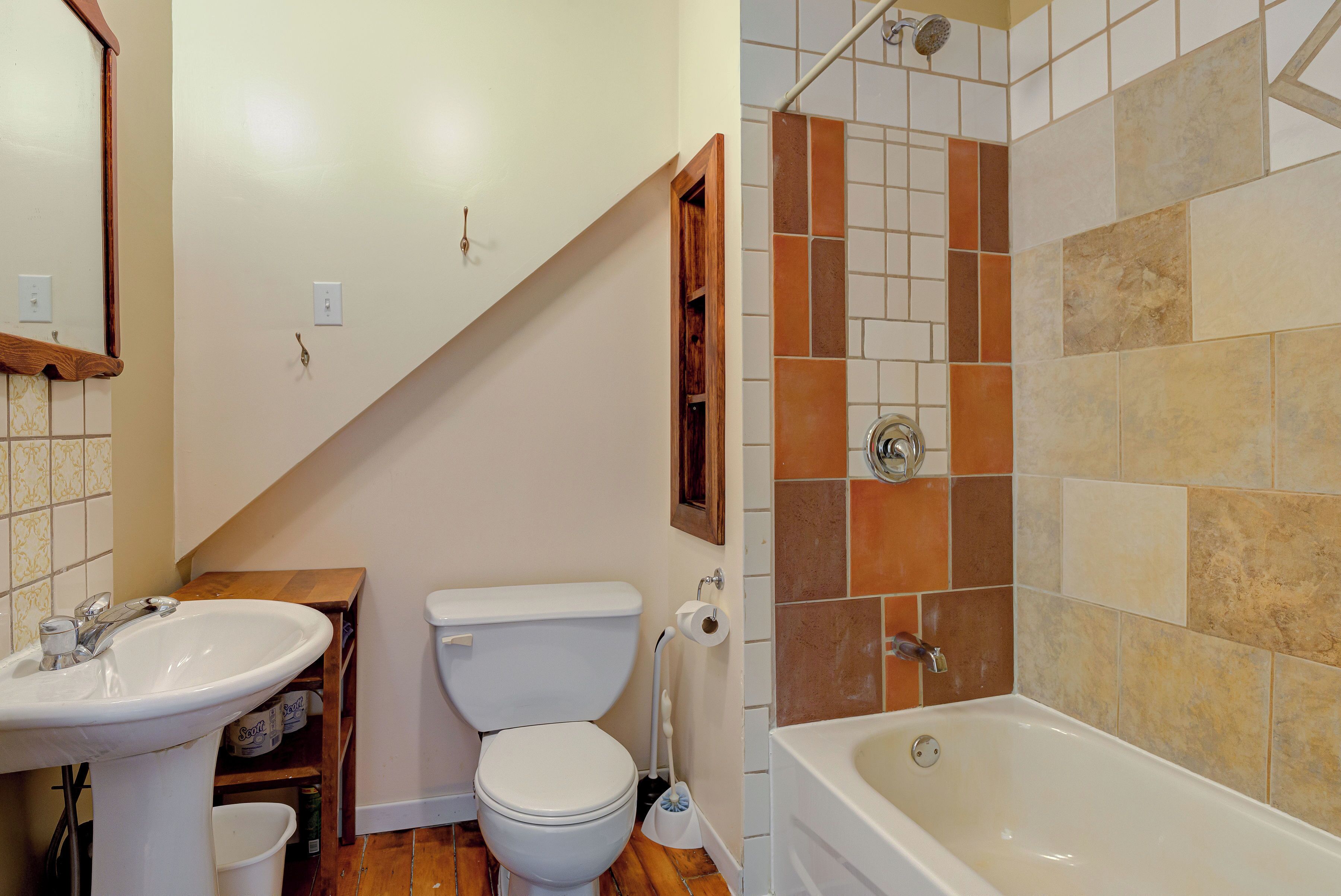A bathroom with a sink, toilet, and bathtub.