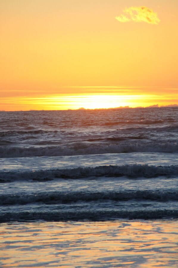 A sunset over the ocean with waves. - Carefree Days at The Beach (Watsonville)