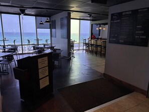 Enjoy ocean views from the dining area, where tables and chairs offer a comfortable space to relax.
