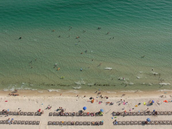 On the beach, sun loungers, beach towels