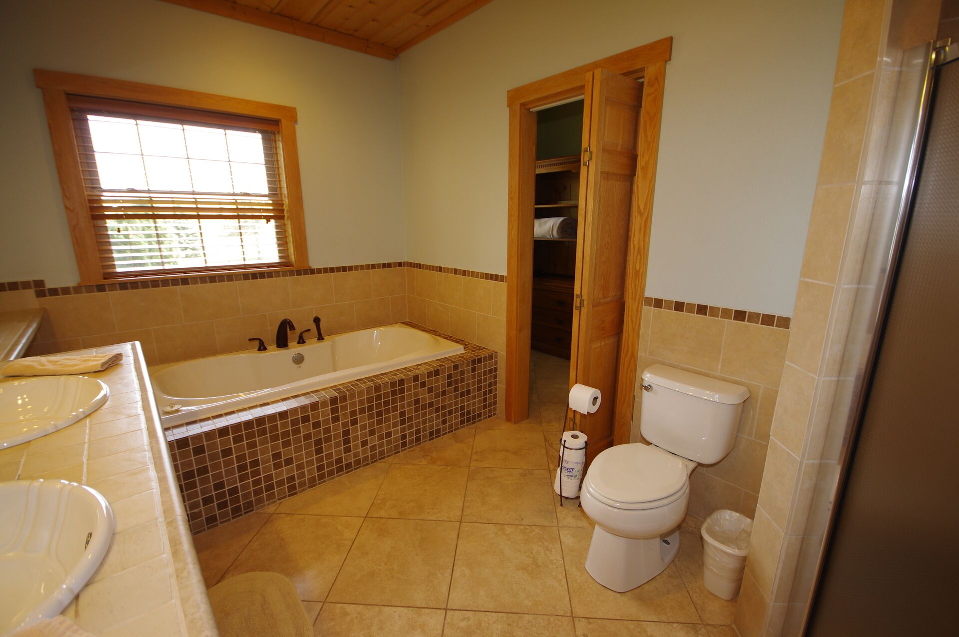 A bathroom with a bathtub, toilet, and sink.