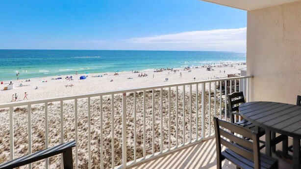 A balcony with a view of a beach and ocean. - Seacrest 405 1 Bedroom Condo by RedAwning (Gulf Shores)