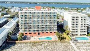 A multi-story hotel with a pool area and beach view. - Seacrest 405 1 Bedroom Condo by RedAwning (Gulf Shores)