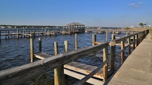 A wooden pier extending into calm water with a gazebo at the end. - Sea Oats H102 2 Bedroom Condo by RedAwning (Gulf Shores)