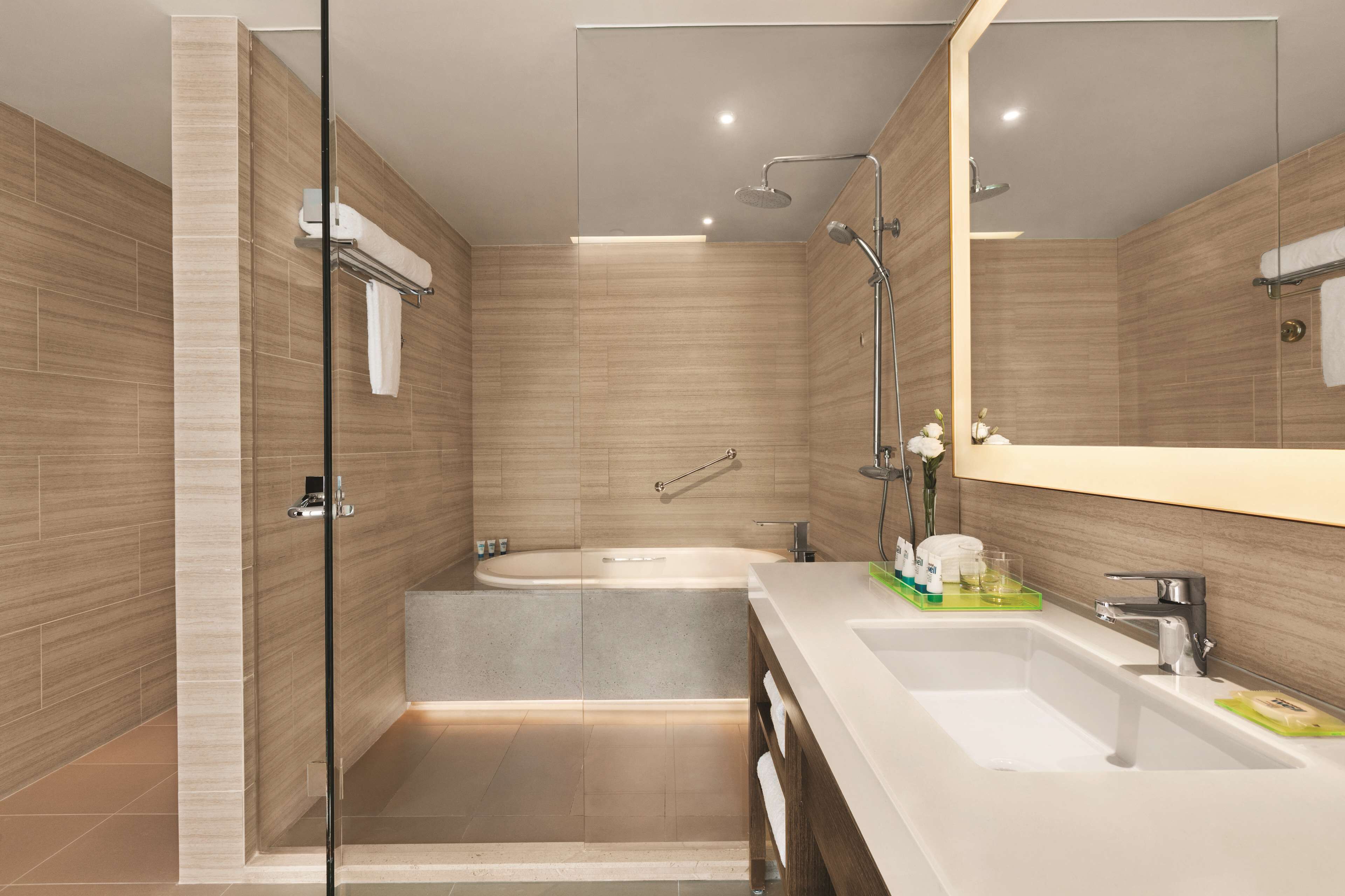 two-bedroom kitchen suite with one king bed and two twin beds - with sofa bed | bathroom | hydromassage showerhead, designer toiletries, hair dryer, bathrobes