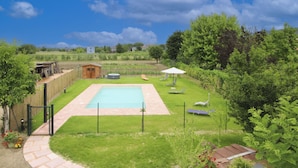 A backyard with a swimming pool, lounge chairs, and a small shed. - Recently restored stone villa with private pool, ideal for couples of friends or families wishing to (Castiglion Fiorentino)