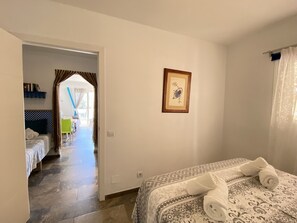 A hotel room with a bed, a framed picture on the wall, and a view of the hallway. - Litoral Burriana Apartment by Casasol (Nerja)