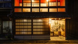 A traditional Japanese building with a wooden facade, a sliding door, and a lantern. - asanogawa (Kanazawa)