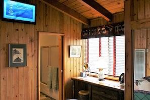 Cozy room with a functional workspace, television, and comfortable seating area.