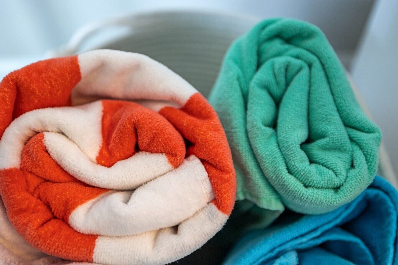 A close-up of folded towels in red, white, and green colors.