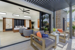 A modern hotel room with a bed, seating area, and a view of the outdoors. - Experience luxury in Scottsdale with heated pool, hot tub, pickleball, & slide! (Scottsdale)
