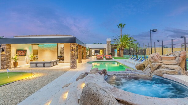 A modern outdoor pool area with a hot tub, lounge chairs, and a restaurant. - Experience luxury in Central Scottsdale with heated pool, pickleball, & slide! (Scottsdale)