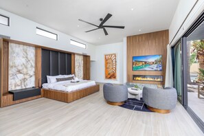 A modern bedroom with a large bed, a ceiling fan, and artwork on the walls. - Experience luxury in Scottsdale with heated pool, hot tub, pickleball, & slide! (Scottsdale)