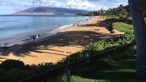 A beach with people, a clear sky, and a mountain in the background. - Breath taking ocean and volcano views! Pool,Close to beaches and everything else (Kihei)