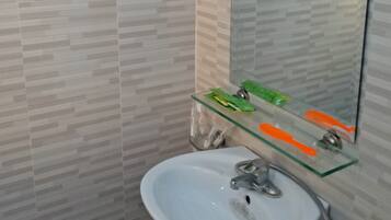 Quadruple Room | Bathroom | Shower, free toiletries, slippers, towels