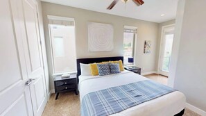 A bedroom with a bed, bedside tables, a ceiling fan, and a window. - Entrada at Moab - 430, Brand New 4 Bedroom Luxury T (Moab)