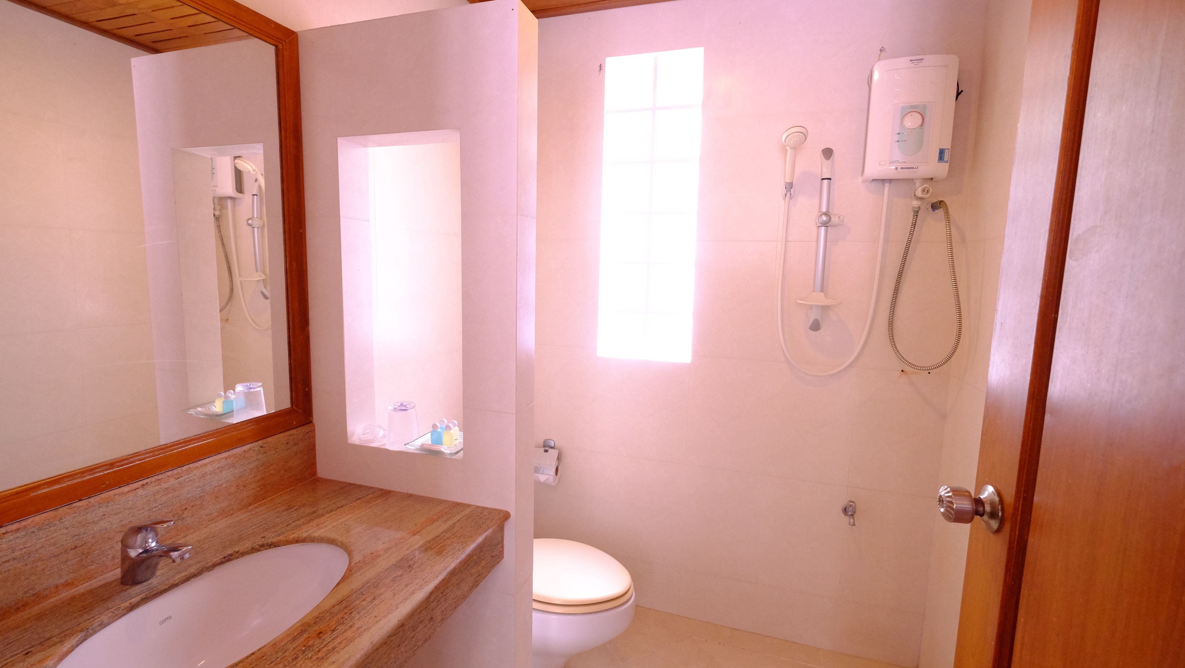 A bathroom with a sink, toilet, and shower.