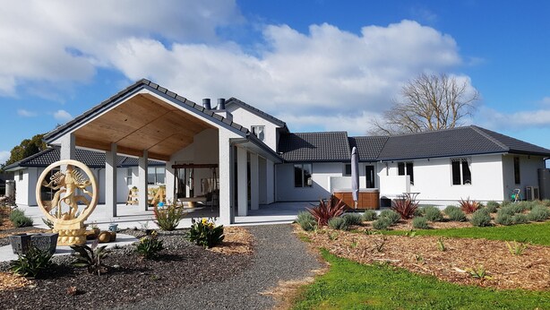 A modern house with a covered porch, a hot tub, and a well-maintained garden. - BRUNTWOODLODGE - Adults Only (Tamahere)