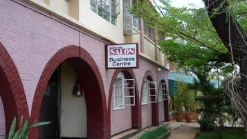 A building with a sign reading "SALON Business Centre" and a brick facade with arched doorways.