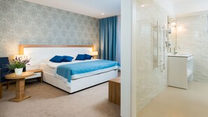 A modern hotel room with a bed, bedside table, and a small desk with a chair. - Hotel Corner (Split)