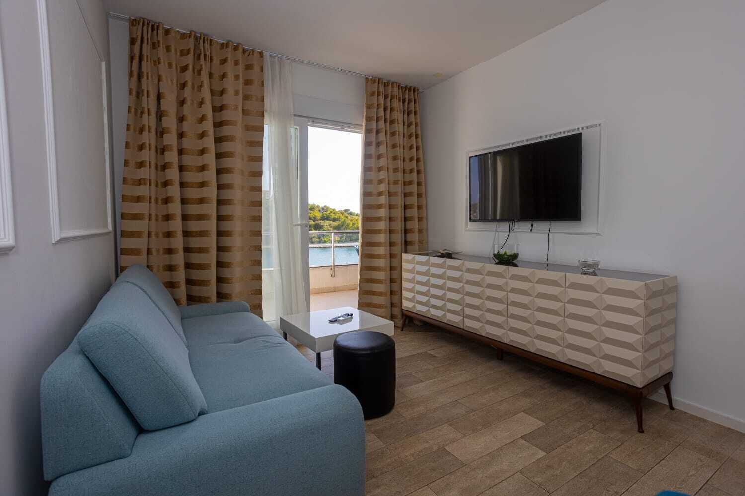 standard apartment | living area | 120-cm smart tv with satellite channels, tv, ipod dock