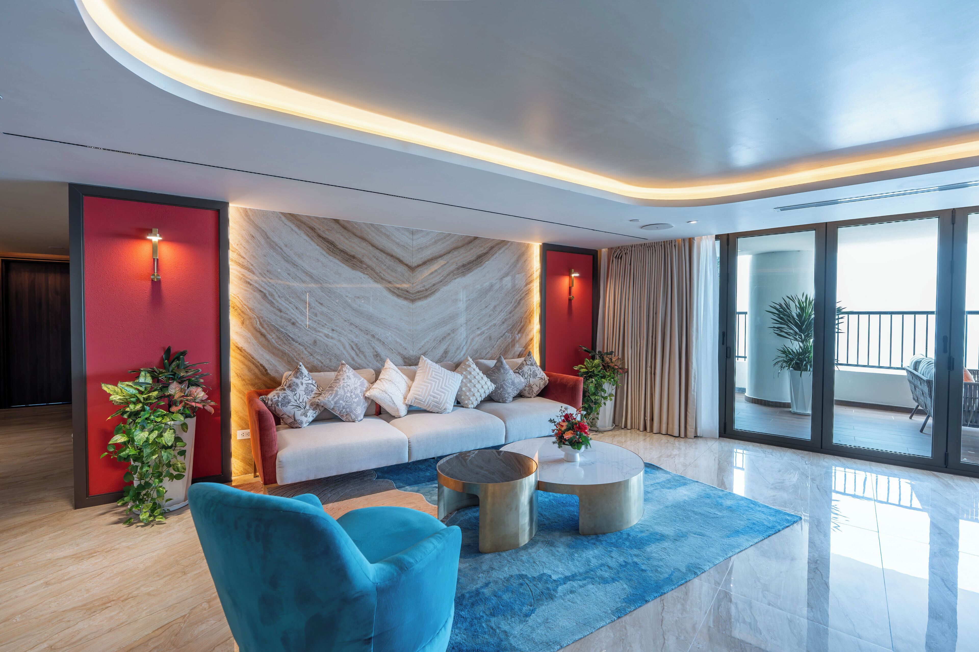 A modern living room with a sofa, two armchairs, a coffee table, and a large window with a view.
