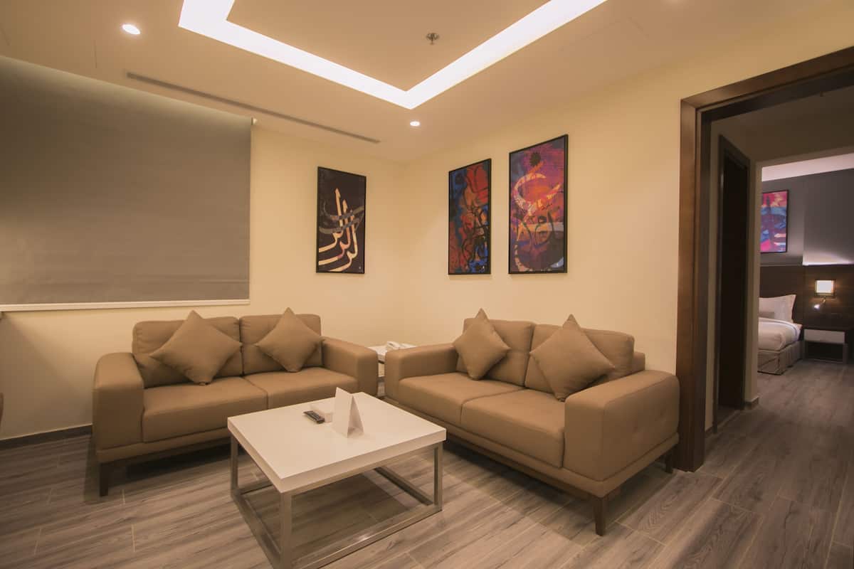 A modern living room with two sofas, a coffee table, and artwork on the walls.