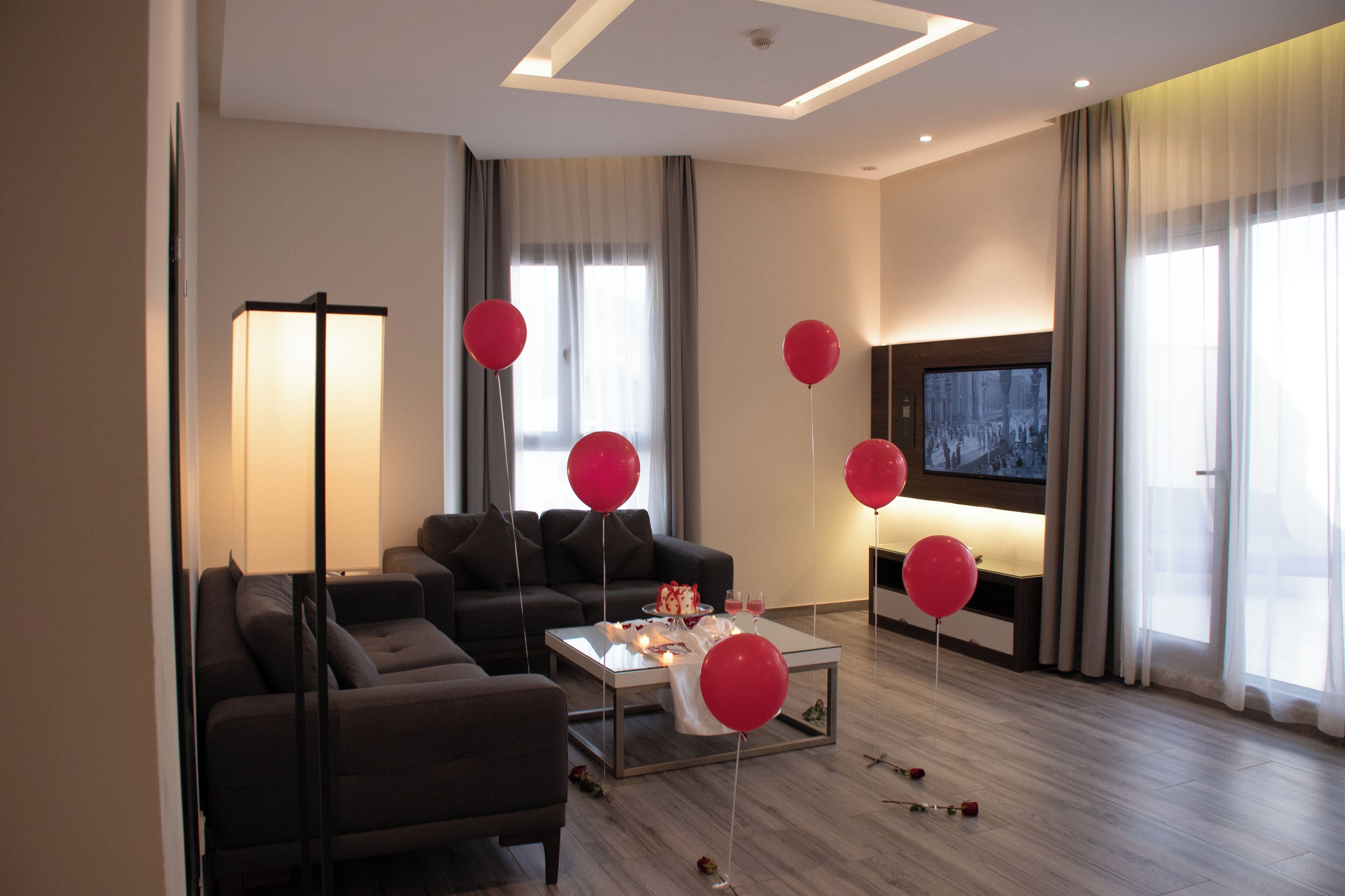 A modern living room with a sofa, a coffee table, and a flat-screen TV.