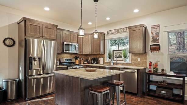 A modern kitchen with stainless steel appliances, wooden cabinets, and a central island with stools. - Trails End Retreat - Perfect Retreat Luxury Home, Guest Quarters, A/C, Foosball, Ping Pong (Bend)