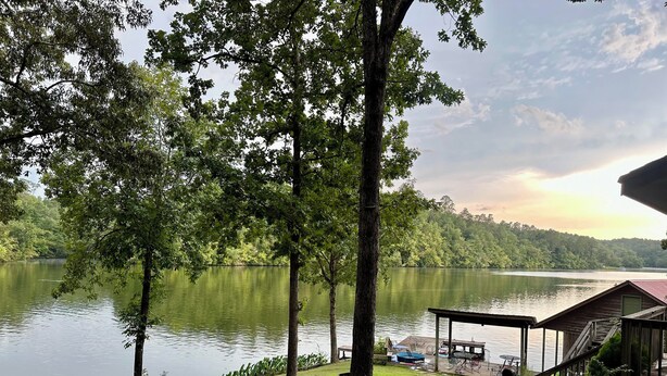 A lakeside property with a gazebo, a dock, and a grassy area. - Family house by the lake (Shelby)