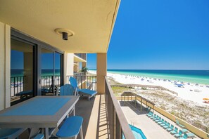 A balcony with a view of the beach, a pool, and lounge chairs. - Everything is Better at the Beach! ~ Popular One Bedroom @ Phoenix 1 (Orange Beach)