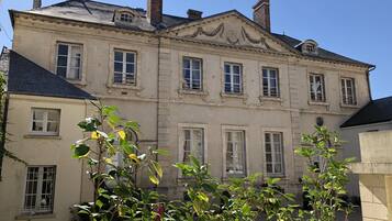 Un bâtiment historique doté de nombreuses fenêtres et d’une façade symétrique.
