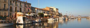 Waterfront shops and restaurants line the marina, offering scenic views.