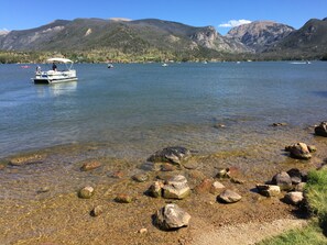 A lake with boats and a rocky shoreline.