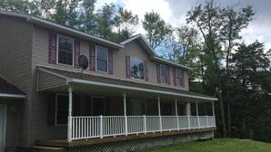 A two-story house with a covered porch and a fenced yard. - Your Home away from Home. Large Groups Welcome (Hamden)