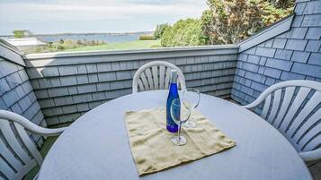 Enjoy a serene outdoor retreat with a seating area featuring a round table and two chairs.
