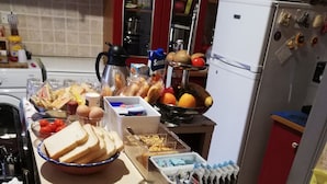 A buffet with various food items including bread, eggs, fruits, and croissants. - B&B Aloi Rooms (Catania)