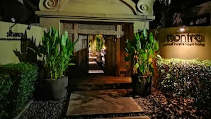 A hotel entrance with a sign reading "montre" and a pathway leading to the interior. - Montra Samui (Koh Samui)