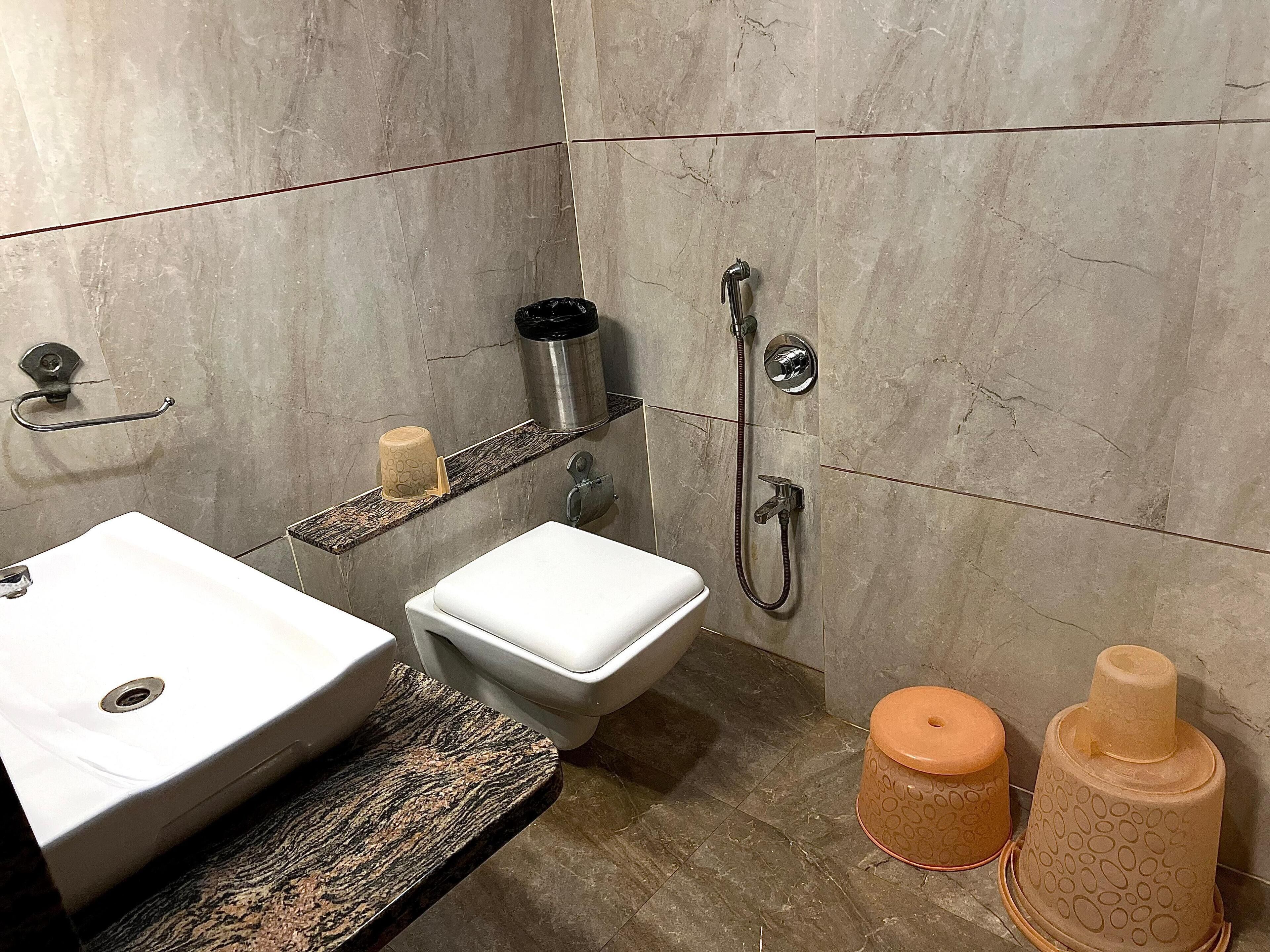 A bathroom with a sink, toilet, and shower.