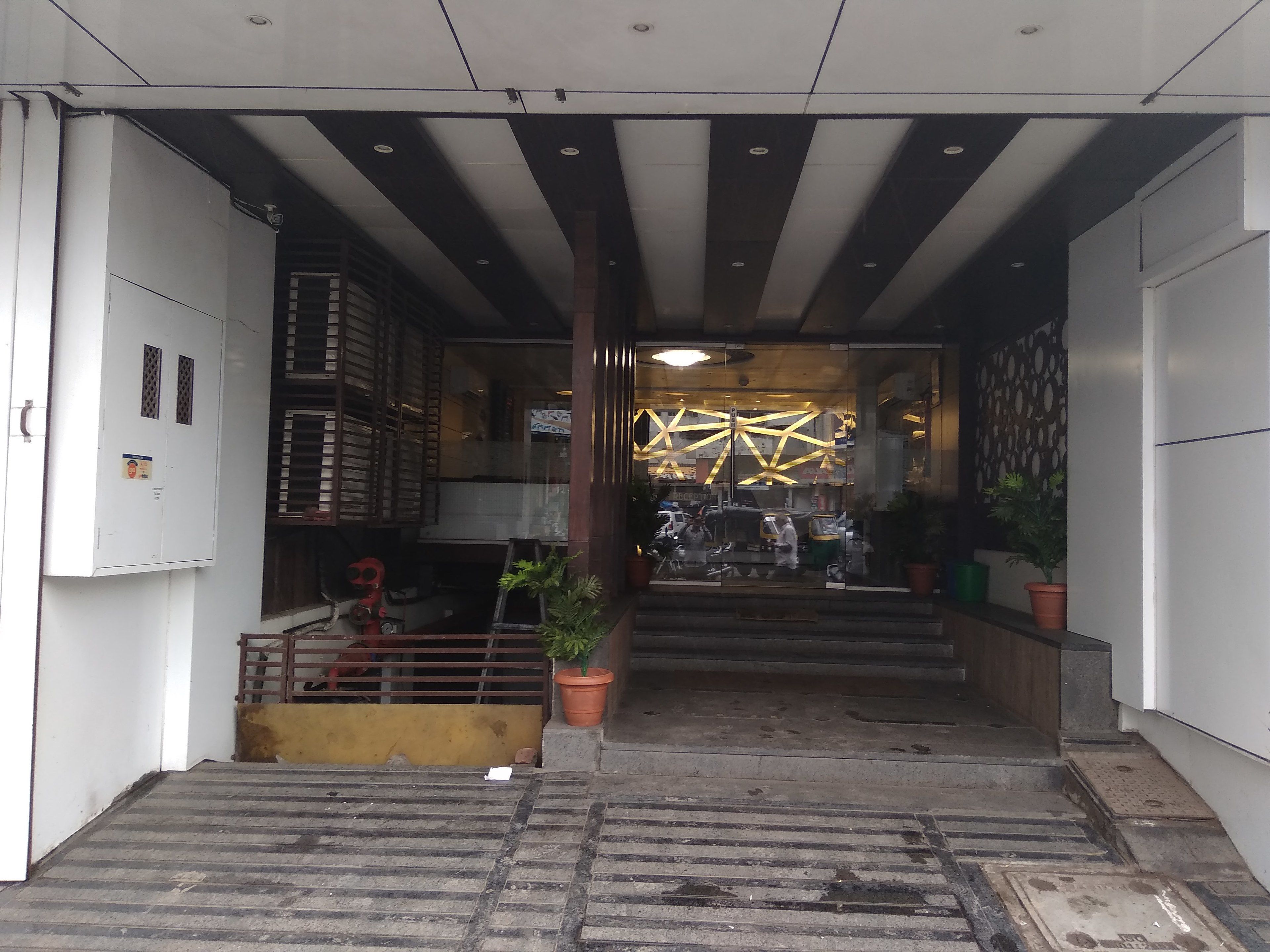 A building entrance with a staircase leading to a covered area.