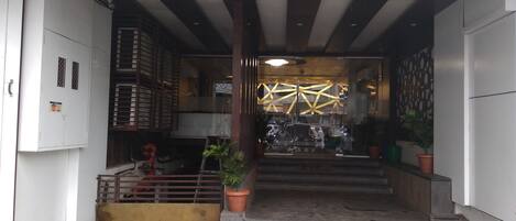 A building entrance with a staircase leading to a covered area.
