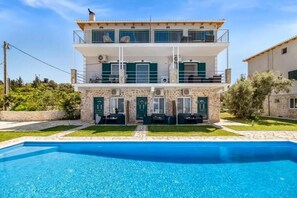 A two-story building with a swimming pool in front. - Gountis apartment (Lefkada)