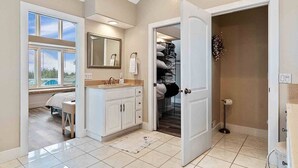 A bathroom with a large mirror, a sink, and a storage closet. - Pets OK, Amazing View, Steps to Town & Beach (Seas) (Long Beach)