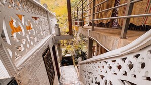A staircase with intricate white railings and a patterned floor. - Vista Hermosa (San Rafael)